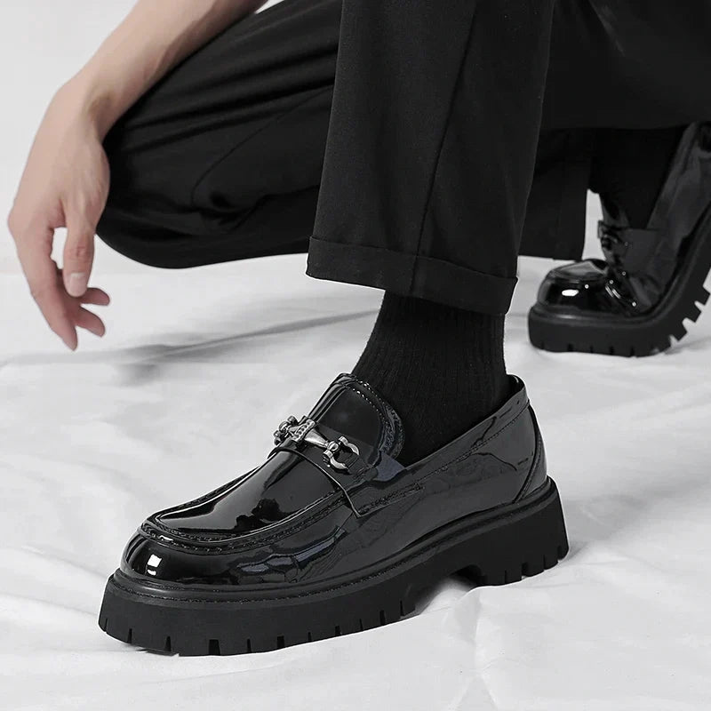 Magnus Black patent loafers worn with socks - seated lifestyle